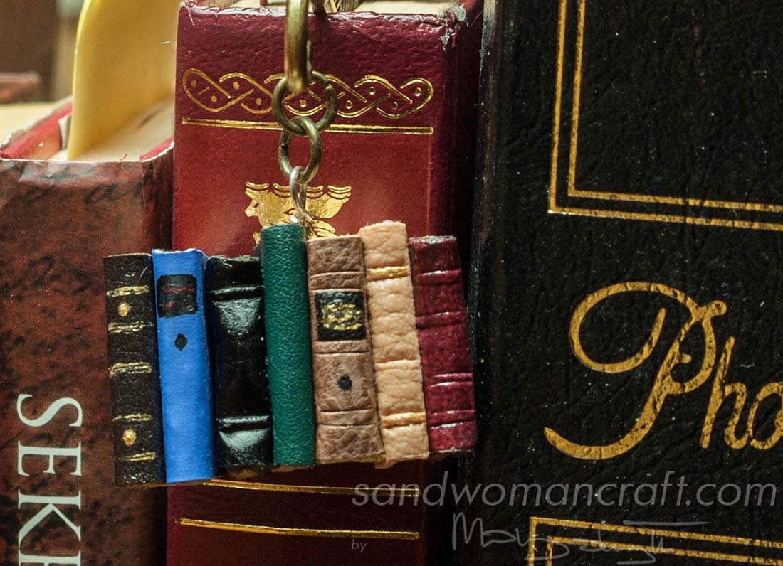 Bookmark with handmade miniature leather books and feather charm
