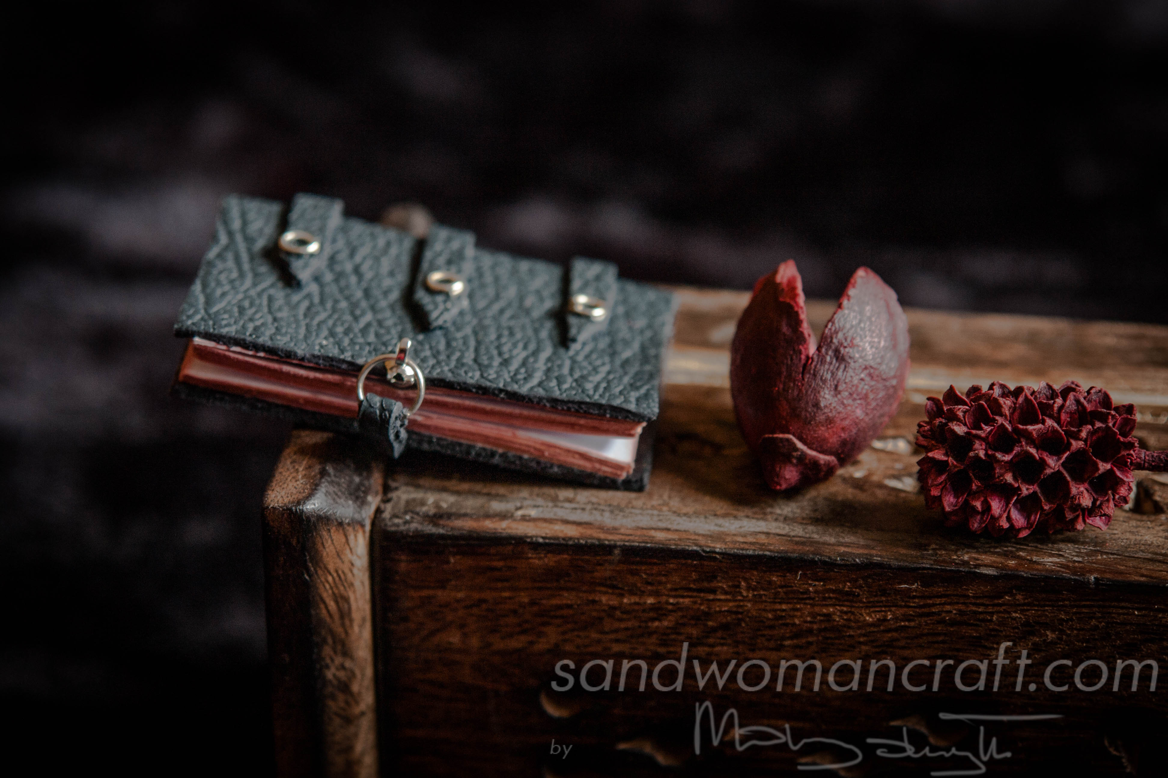 Miniature black leather decorated book with red edge
