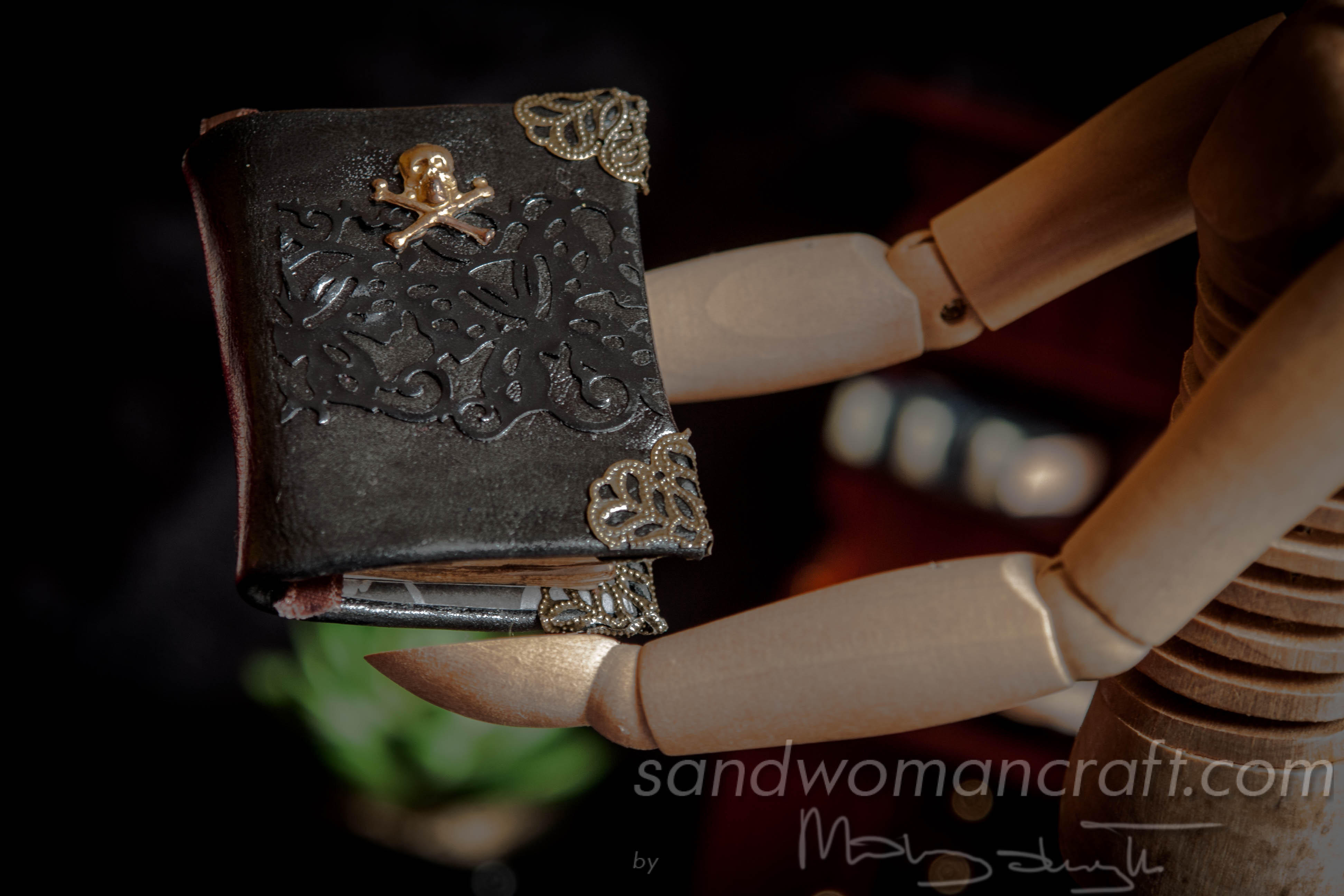 Black leather miniature book with brass skull and hidden potion inside