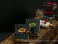 Miniature leather Book Of Spells with green cabochon