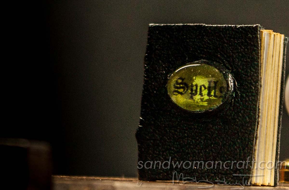 Miniature leather Book Of Spells with green cabochon