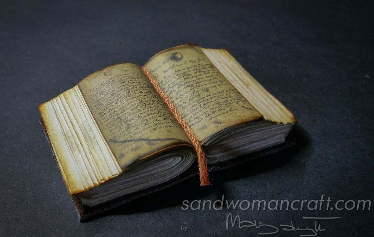 Miniature open thick book