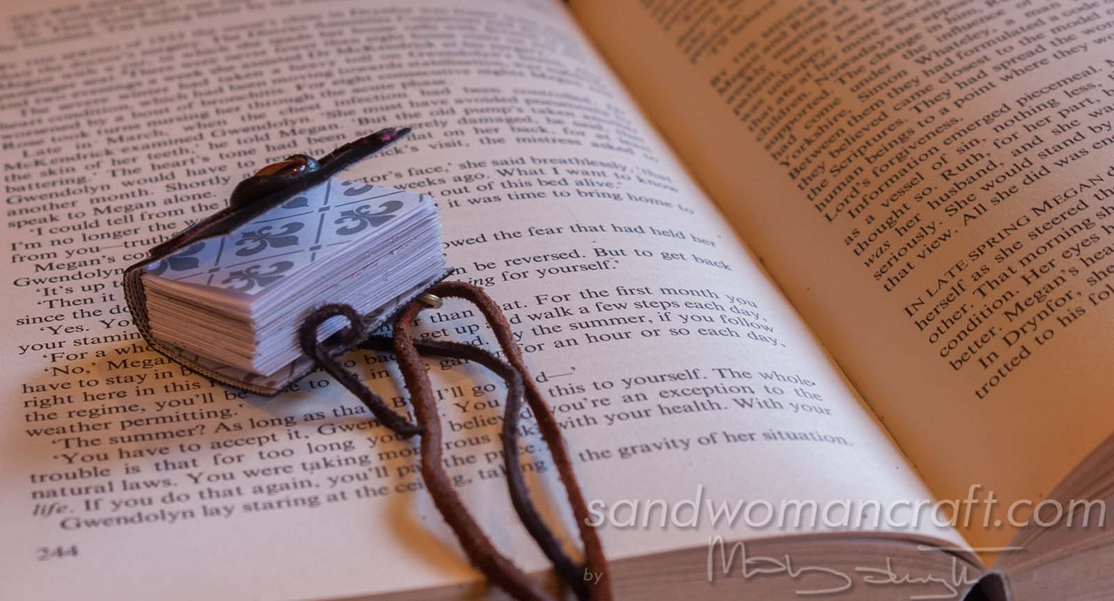 Miniature leather book necklace with real book to read inside. Da Vinci theme