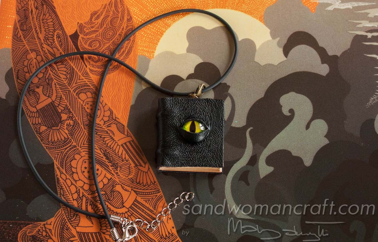 Miniature leather book necklace with green dragon's eye