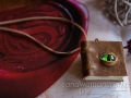 Miniature book necklace, olive-brown textured leather, front cover with glass Dragons's eye