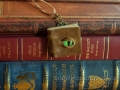 Miniature book necklace, olive-brown textured leather, front cover with glass Dragons's eye