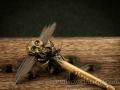 Miniature magic wand with brass skull and feathers