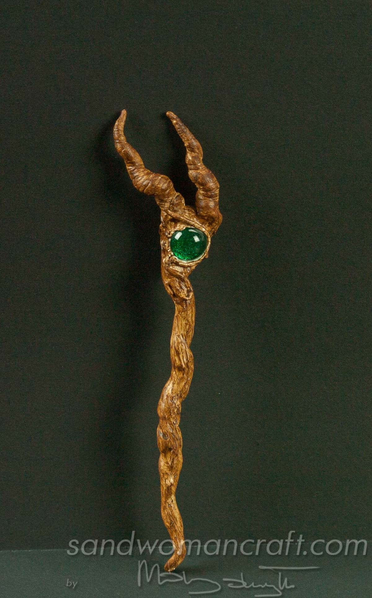Miniature magic walking stick with horns and green glass stone