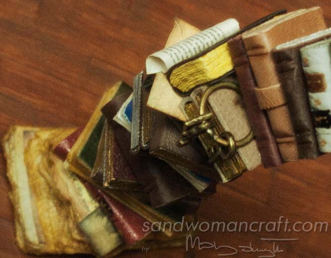 Miniature leather books stacked