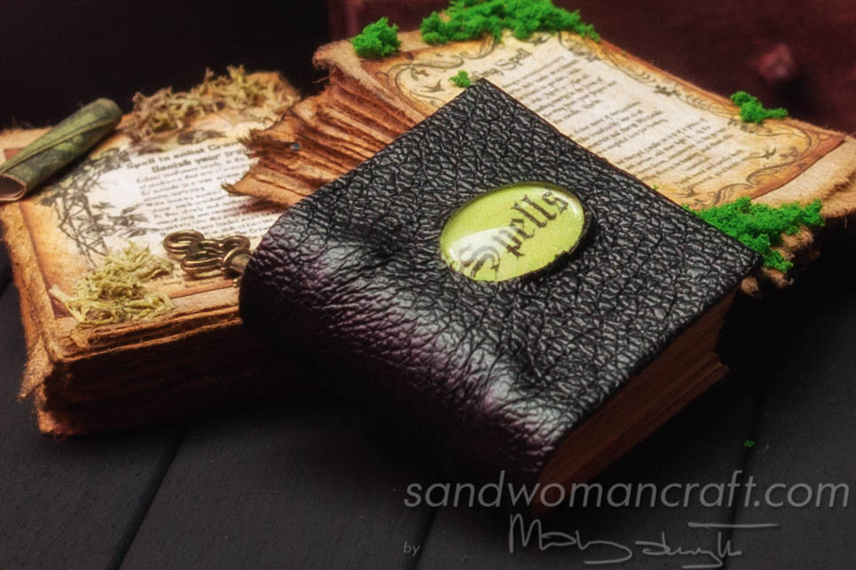 Miniature leather book of spells with glass cabochon