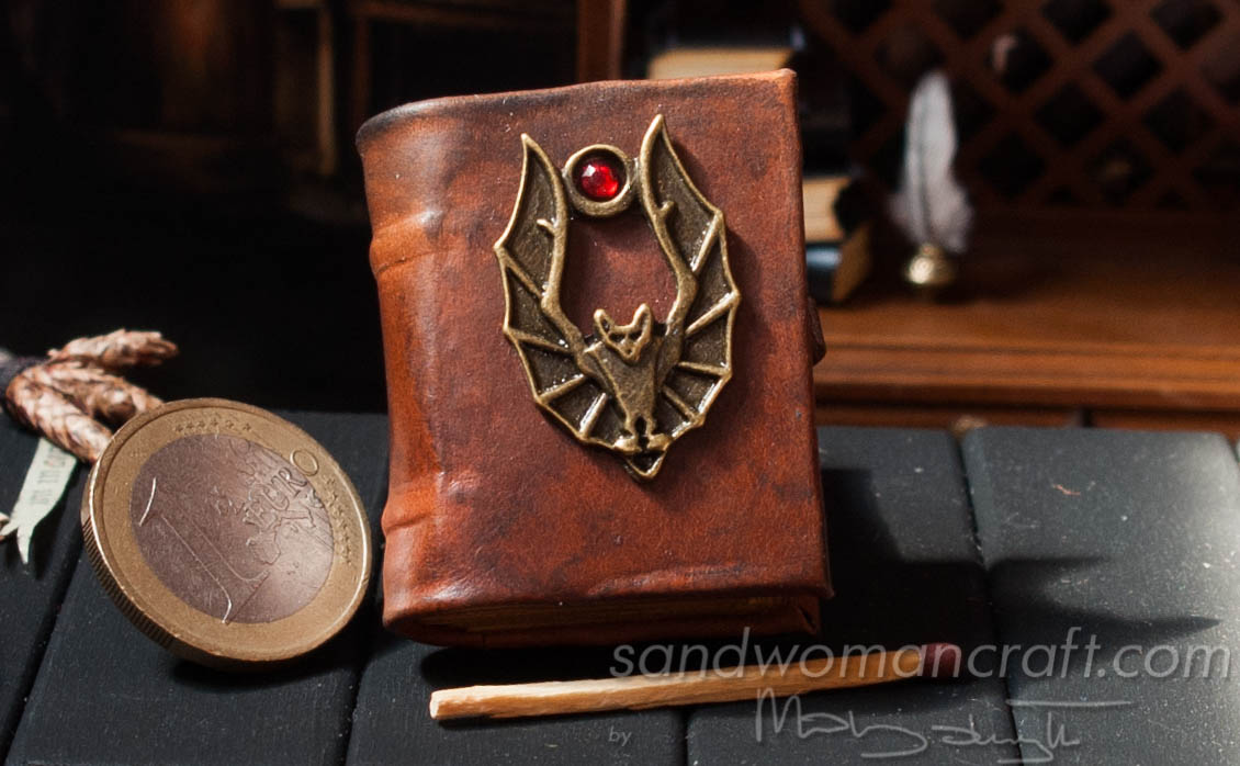 Miniature leather bound book with bat in 1:6 scale