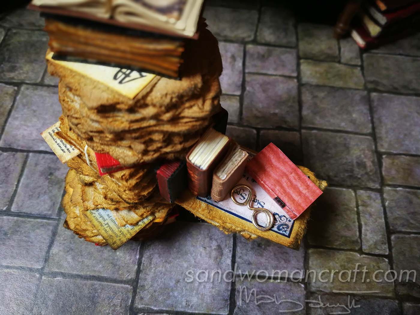 Dollhouse miniatures pile with aged papers and books