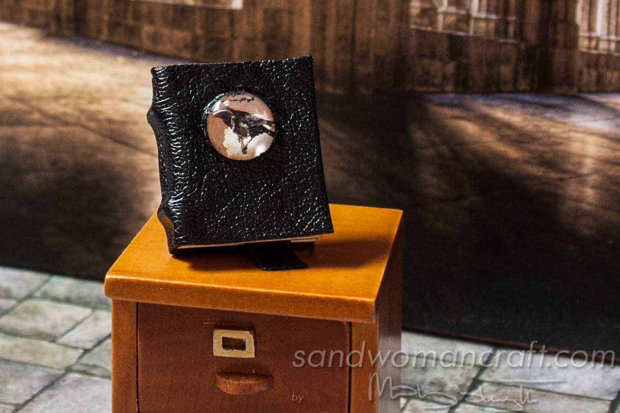 Miniature leather book with crow cabochon