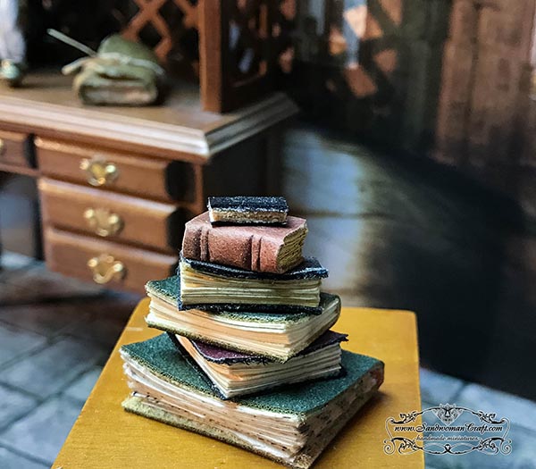 Small stack of miniature leather books 